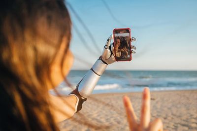 Studio-VF_Woman_Beach_Prosthetic_Arm_Phone_CMYK.jpeg